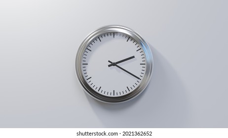 Glossy chrome clock on a white wall at twenty past two. Time is 02:20 or 14:20