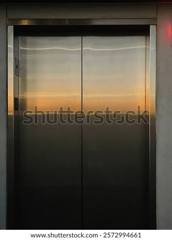 glossy industrial elevator with sunset reflection