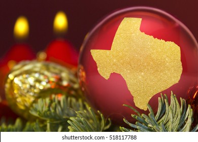A glossy red bauble with the golden shape of Texas.(series)