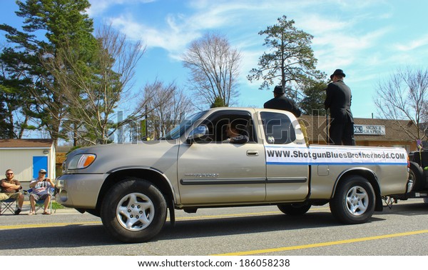GLOUCESTER, VA - April 5, 2014: The\
Shotgun Blues Brotherhood band in the Daffodil parade, The Daffodil\
fest and Parade is a regular event held each spring\
