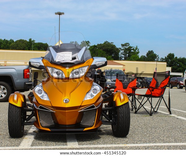 GLOUCESTER, VA - JULY 9, 2016: A gold Can Am Spyder\
reversed three wheeled motorcycle at the Collector Car Appreciation\
Day Car Show sponsored by the Middle Peninsula Classic Cruisers car\
club.