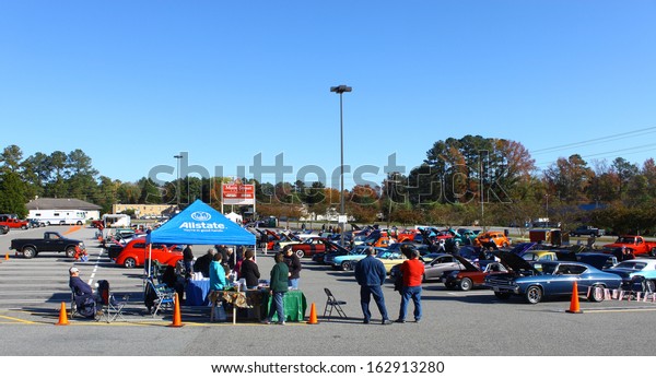 GLOUCESTER, VA- NOVEMBER 9: An Allstate insurance\
tent and the parking lot in the Shop with a Cop Car Show in\
Gloucester, Virginia on November 9,\
2013