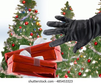 Gloved Black Hand Of A Thief Stealing Christmas Gifts Next The Xmas Trees