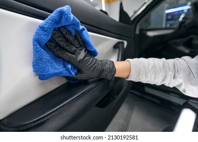 Gloved Hand Drying Car Interior With Microfiber Towel