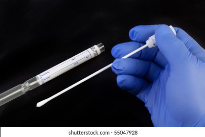 A Gloved Hand Holding A Medical Swab