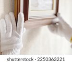 Gloved hand holding a picture frame