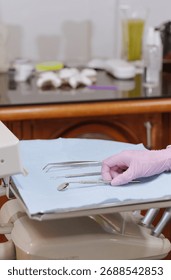 Gloved hand selecting instruments from a disposable tray for a dental procedure