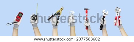 Gloved hands holding set construction tools wrench, metal profile connector, spanner, hammer, caliper, micrometer, metal scissors, measure tape, ruler, rangefinder, laser ruler on blue