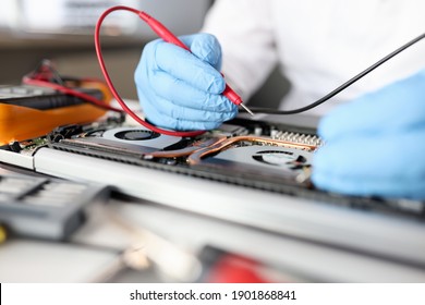 Gloved Handyman Repairs Motherboard. Maintenance And Repair Of Computer Equipment Concept