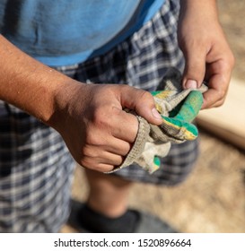 Gloves in the hands of a worker.