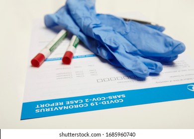 Gloves And Swabs On Form Used For Reporting Of Covid-19 Coronavirus Case