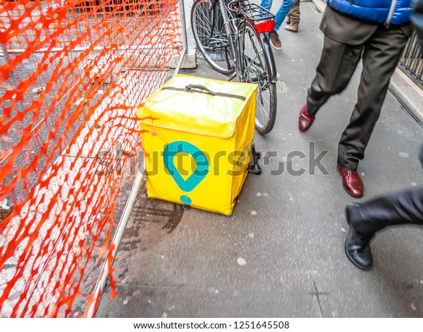 Glovo Rider Food Delivery\
Service Backpack on the Ground in the Street of\
Milan,Italy-November 2018