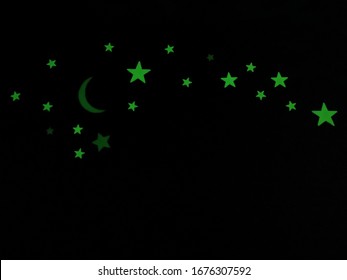 Glow In The Dark, Bright Neon Green Star Stickers Glowing On A Bedroom Wall At Night.