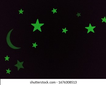 Glow In The Dark, Bright Neon Green Star Stickers Glowing On A Bedroom Wall At Night.