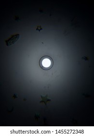 Glow In The Dark Stars Around A Lightbulb On A Bedroom Ceiling