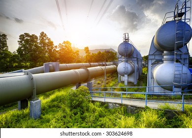 Glow light of petrochemical industry water tank on sunset