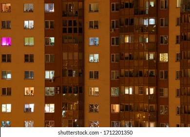 Glowing apartment windows at night where each occupant has his own privacy - Powered by Shutterstock