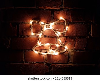 Glowing bell on a brick wall in the dark - Powered by Shutterstock