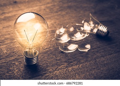 Glowing and broken light bulb comparison concept, problem and solution, failure and success, learning from mistake