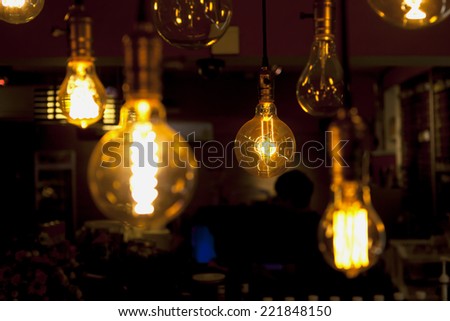 glowing and broken tungsten lamps, heated filament light bulb, incandescent illumination on dark background