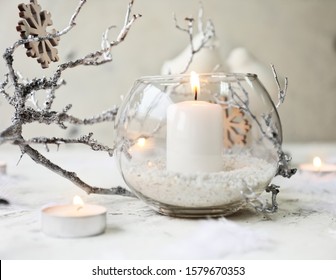 Glowing Candles With Christmas Decor On White Background