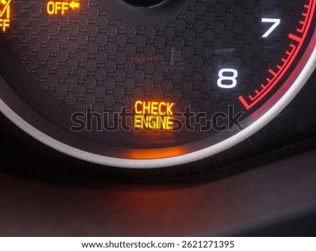 Glowing check engine warning light signaling potential automotive diagnostic issue, highlighting vehicle maintenance need