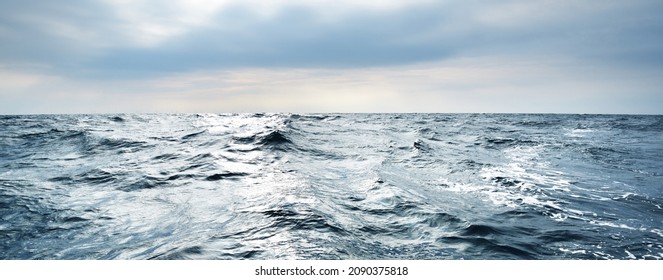 Glowing clouds above the open Baltic sea before the thunderstorm. Sweden Dramatic sky, epic seascape. A view from the yacht. Sailing in a rough weather