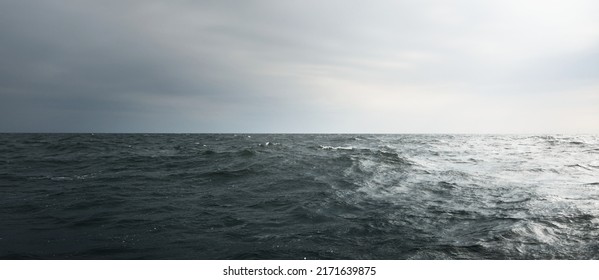 Glowing Clouds Above The Sea. Waves, Water Splashes. Dramatic Sky After The Storm, Epic Seascape. A View From The Yacht. Sailing In A Rough Weather. Nature, Travel Destinations, Cruise