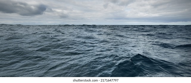 Glowing Clouds Above The Sea. Waves, Water Splashes. Dramatic Sky After The Storm, Epic Seascape. A View From The Yacht. Sailing In A Rough Weather. Nature, Travel Destinations, Cruise