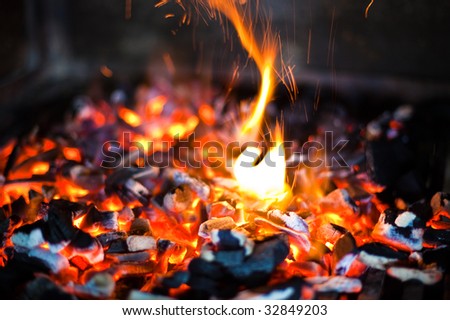 Glowing coals in a barbeque grill