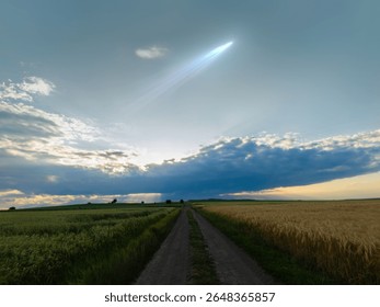 Glowing comet with a long tail in the sky at sunset. Celestial body above the clouds, astronomical landscape.