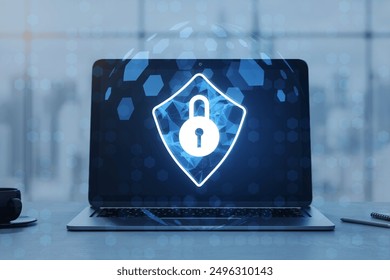 A glowing cybersecurity lock icon displayed on a laptop screen with a holographic effect. Blurred office background. Concept of internet safety, data protection, and online security