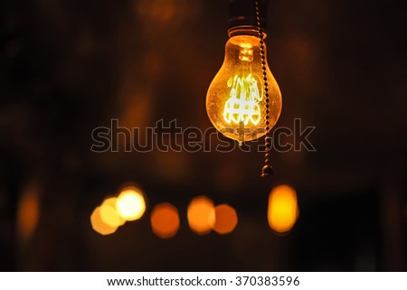Glowing Edison's light bulbs on the dark background.