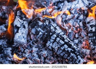 Glowing embers in hot red color, abstract background. The hot embers of burning wood log fire. Firewood burning on grill. Texture fire bonfire embers - Powered by Shutterstock