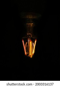 glowing filament of an incandescent bulb  