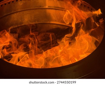 Glowing flames dance inside a fire pit, casting a warm and inviting glow.
