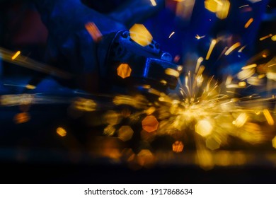 Glowing flow of steel metal welding spark dust particles shine in the sparkly dark background