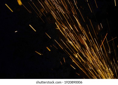 Glowing Flow Of Steel Metal Welding Spark Dust Particles Shine In The Sparkly Dark Background