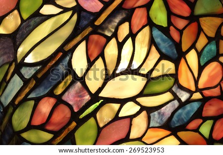 Glowing Glass Art. Backlit hand crafted glass art from church window with flowers and vivid colors.