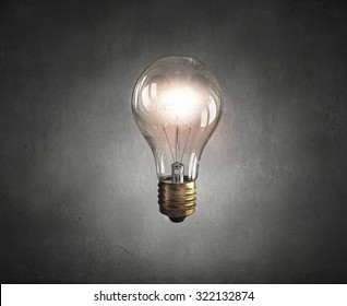 Glowing Glass Light Bulb On Dark Background