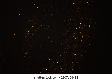 Glowing golden glitter bokeh festive lights abstract dark overlay background - Powered by Shutterstock