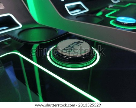 Glowing green neon spin button on a modern slot machine console, perfect for casino gambling, luck, gaming, and betting concepts.