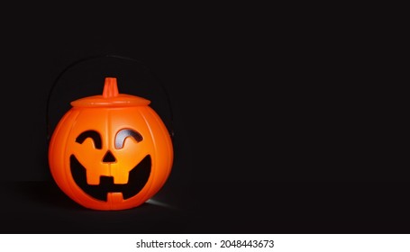 Glowing Halloween handbag in the form of a pumpkin on a black background.Halloween trick or treat!?opy space for text. Banner