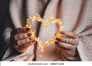 Glowing Heart In The Hands Of A Woman. Happy Valentine's Day. Plaid, Comfort, Winter, Heart. Holiday Manicure, Nail Art