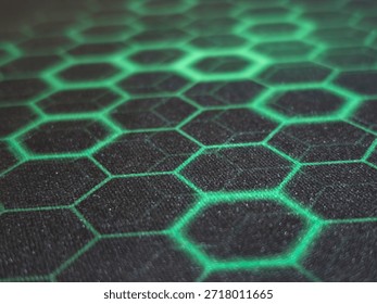 Glowing hexagonal pattern on dark surface creating futuristic technology background abstract geometry and digital design concept
