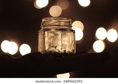 glowing jar held in palm of hand with cozy lighting - Powered by Shutterstock