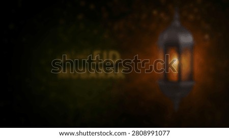 A glowing lantern illuminates the words Eid Mubarak against a dark, textured background, symbolizing celebration and tradition.
