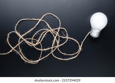 A glowing light bulb at the end of the line of a tangled rope, clarifying complex ideas, solution to solve the confused problem - Powered by Shutterstock