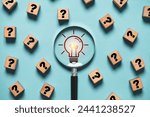 Glowing light bulb inside magnifier glass among question mark for focus and concentrate of creative thinking idea and problem solving concept.