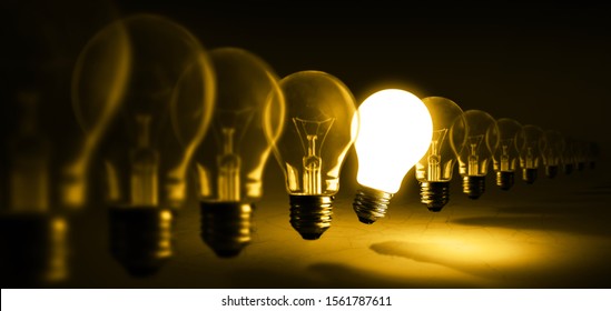 Glowing light bulb on orange background, idea concept - Shutterstock ID 1561787611